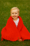Hand-knitted red baby blanket made from Alize Puffy Baby yarn, 100% micro polyester, hypoallergenic and antibacterial, perfect for delicate baby skin